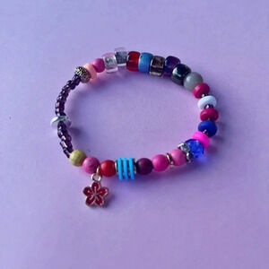 Handmade beaded statement bracelet with flower charm